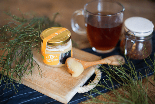 jar and spoon of raw honey