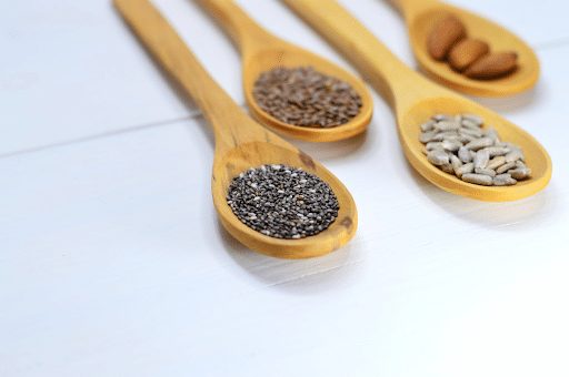 spoons of chia, flax, and sunflower seeds