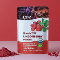 “A stand-up pouch of LOOV Freeze-Dried Organic Wild Lingonberry Powder in red and white packaging, featuring images of bright red lingonberries and green leaves; a small mound of fine red powder is shown in front of the pouch.”