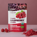 “A stand-up pouch of LOOV Freeze-Dried Organic Raspberry Powder with red and white packaging, showing raspberries on the front. Beside the pouch is a small heap of bright red raspberry powder.”