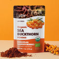 “A stand-up pouch of LOOV Organic Sea Buckthorn Powder, air-dried. The packaging shows images of bright orange sea buckthorn berries and has a white and orange label with 'Organic Sea Buckthorn Powder' text, along with green organic certification seals. A small mound of the powder is shown in front of the pouch.”